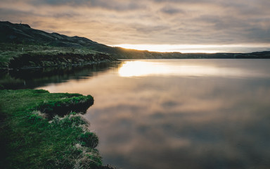 lake in iceland with sunset and reflection of water
