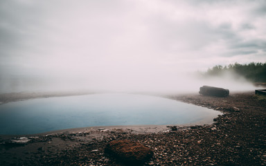 geysir hot very blue water spring with steam iceland