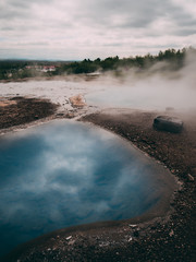 geysir hot very blue water spring with steam iceland