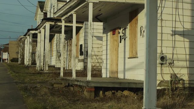 Cinematic Crane Shot Of Run Down Houses.