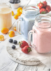 Berry smoothies on the wooden board