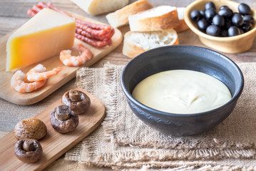 Bowl of fondue with appetizers