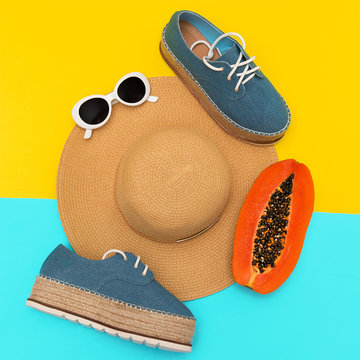 Stylish summer look. Straw hat and denim shoes. Flat lay. Beach lover concept