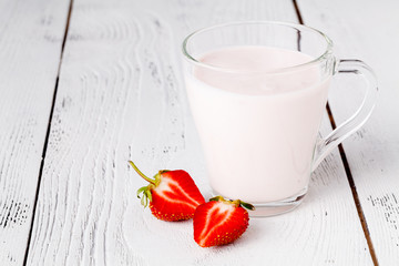 Fresh ripe strawberry with milk in glass