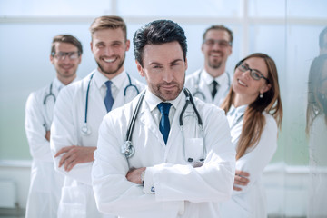 portrait of doctor and medical staff standing in the office