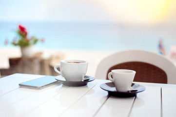 Breakfast for two in a cafe on the beach with two cups of coffee