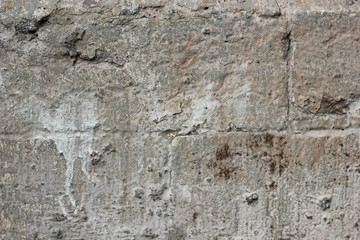Gray old grungy textured concrete wall. Dirty painted stone background, city building wallpaper with place for text