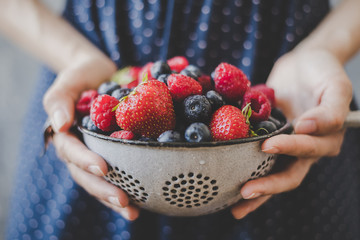 Organic fresh berries. Hands holding fresh juicy berries, closeup - Powered by Adobe