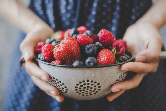 Organic fresh berries. Hands holding fresh juicy berries, closeup