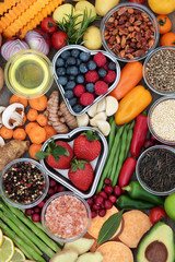 Healthy diet food concept of fruit, vegetables, herbs, spice, grains, nuts, seeds, olive oil and himalayan salt. Foods high in antioxidants, fibre, smart carbs, vitamins, minerals and anthocyanins.