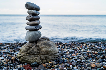 Stone tower of pebbles on sea shore