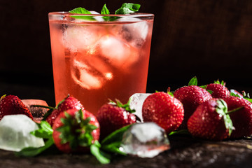 Homemade srawberry mojito and berries on wood