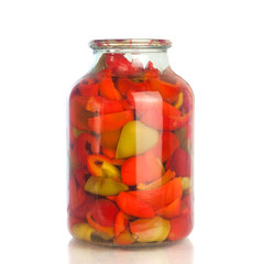 Red peppers canned in a jar. Isolated on a white background