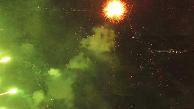 Bright firework explosion in the night sky. Fireworks salute with the black sky background. New years fireworks. Celebrating the Independence Day. Colorful burst of fireworks.