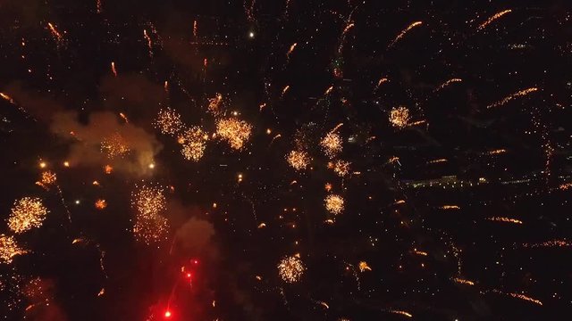 Bright firework explosion in the night sky. Fireworks salute with the black sky background. New years fireworks. Celebrating the Independence Day. Colorful burst of fireworks.