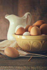 Fresh country eggs in bowl on table