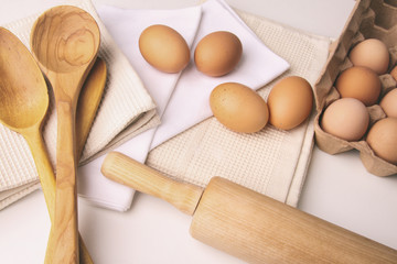Overhead view of eggs and kitchen tools on table