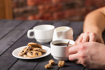 hot black coffee with cookies and beans in cafe