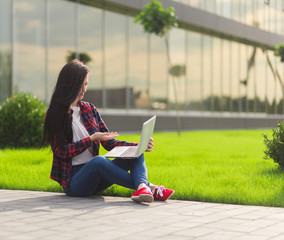 Young brunette woman student working outdoors