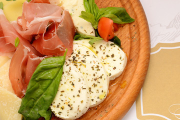 Dry-cured pork slices, tomato and mozzarella