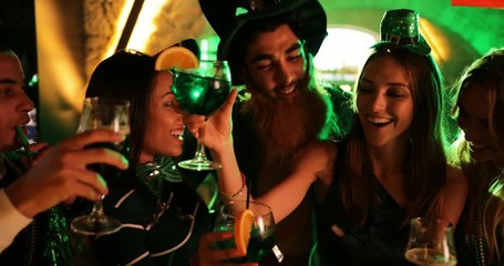 Friends partying and celebrating Saint Patrick's day at night club
