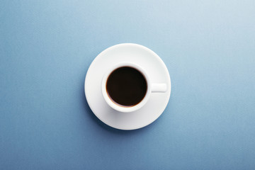 A cup of coffee grey background. Top view, central composition.