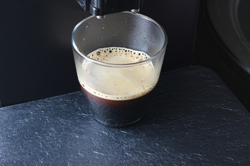 coffee glass on a stone background coffee machine
