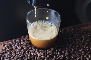 coffee glass coffee beanson a stone background a coffee machine