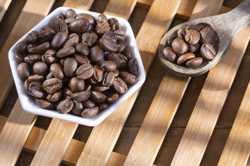 Roasted coffee on the wooden background - Coffea