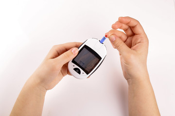 One person with diabetes doing a blood test with a glucometer isolated on white background