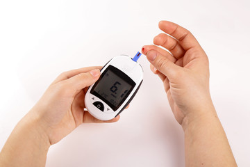 One person with diabetes doing a blood test with a glucometer isolated on white background