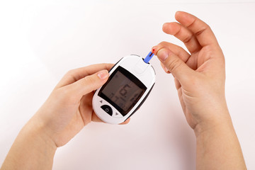 One person with diabetes doing a blood test with a glucometer isolated on white background