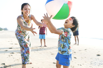 Asian family playing at the beach