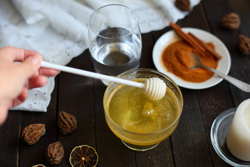 honey and cinnamon on dark wooden background