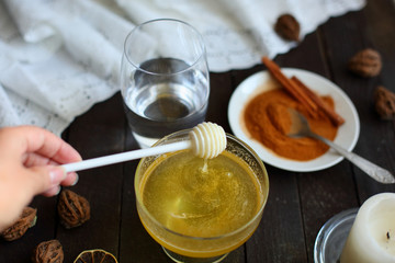 honey and cinnamon on dark wooden background