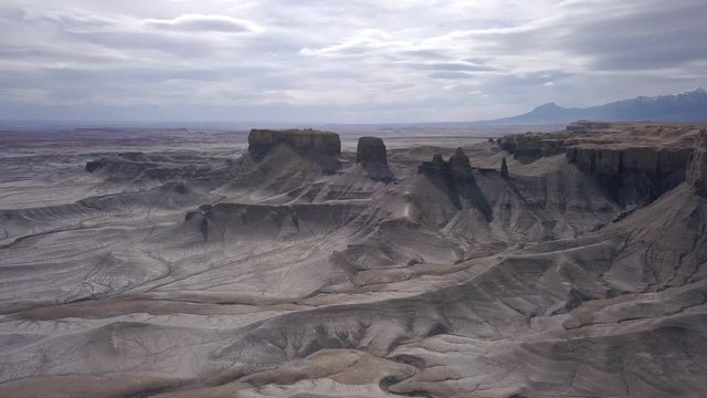 Flying over desert landscape towards rock spires tanding tall in Utah.