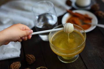 honey and cinnamon on dark wooden background