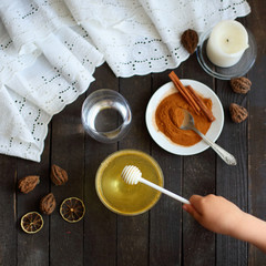 honey and cinnamon on dark wooden background