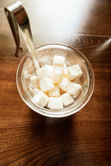 Sugar in the bowl top view on wooden background