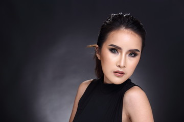 Fototapeta premium Asian Long straight black hair tan skin woman in Black dress