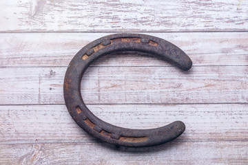 Vintage rusty horseshoe on wood table with copy space