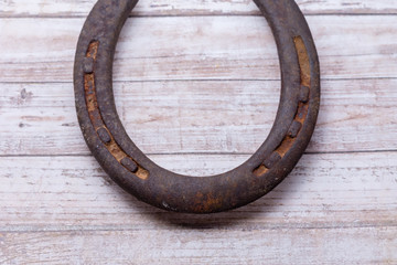 Rusty horseshoe on wood table with copy space