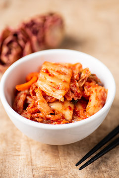 Kimchi cabbage in a bowl with chopsticks, Korean food