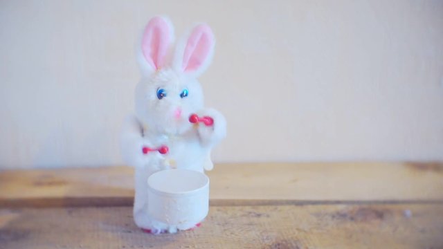 little toy rabbit knocks on the drum