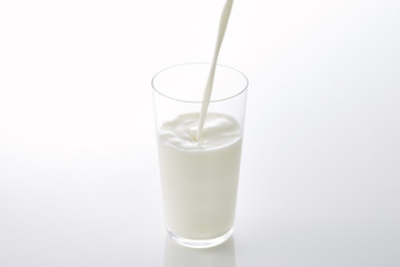 fresh milk in the glass on white background
