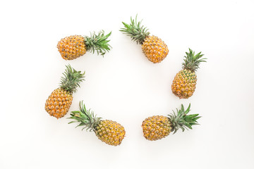 Frame of pineapple fruits on white background. Flat lay, top view. Food concept.