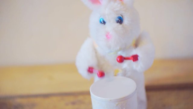 little furry toy rabbit knocks into the drum