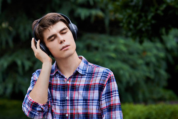 Guy in the forest is listening to music