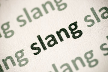 word slang printed on paper macro - obrazy, fototapety, plakaty