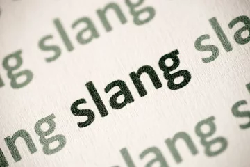 Fotobehang word slang printed on paper macro © aga7ta